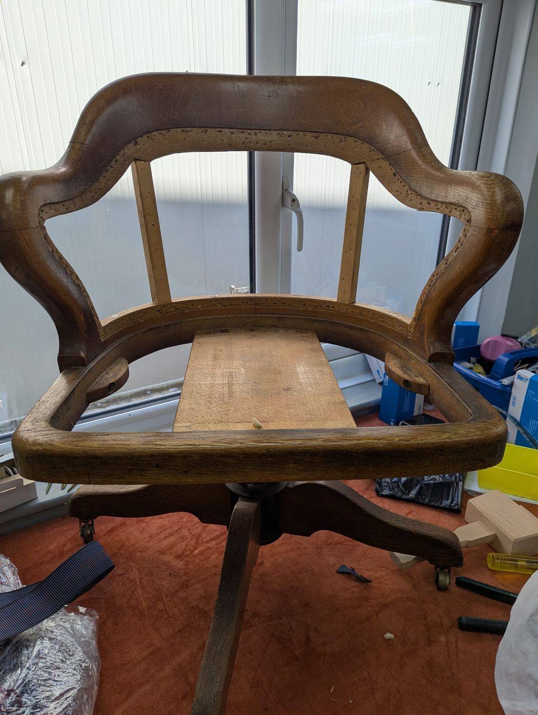 An oak chair frame stripped back in the workshop