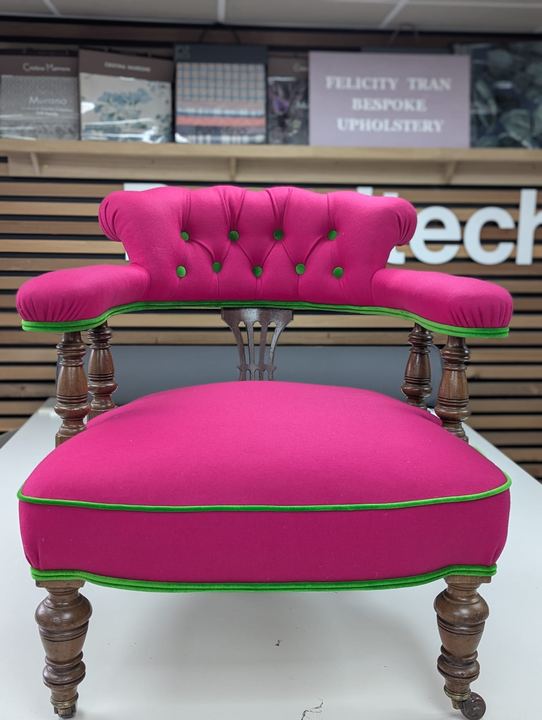The same chair after: deep-buttoned fuchsia with lime-green piping