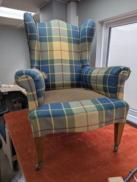 The same wingback before, in a worn blue and yellow tartan